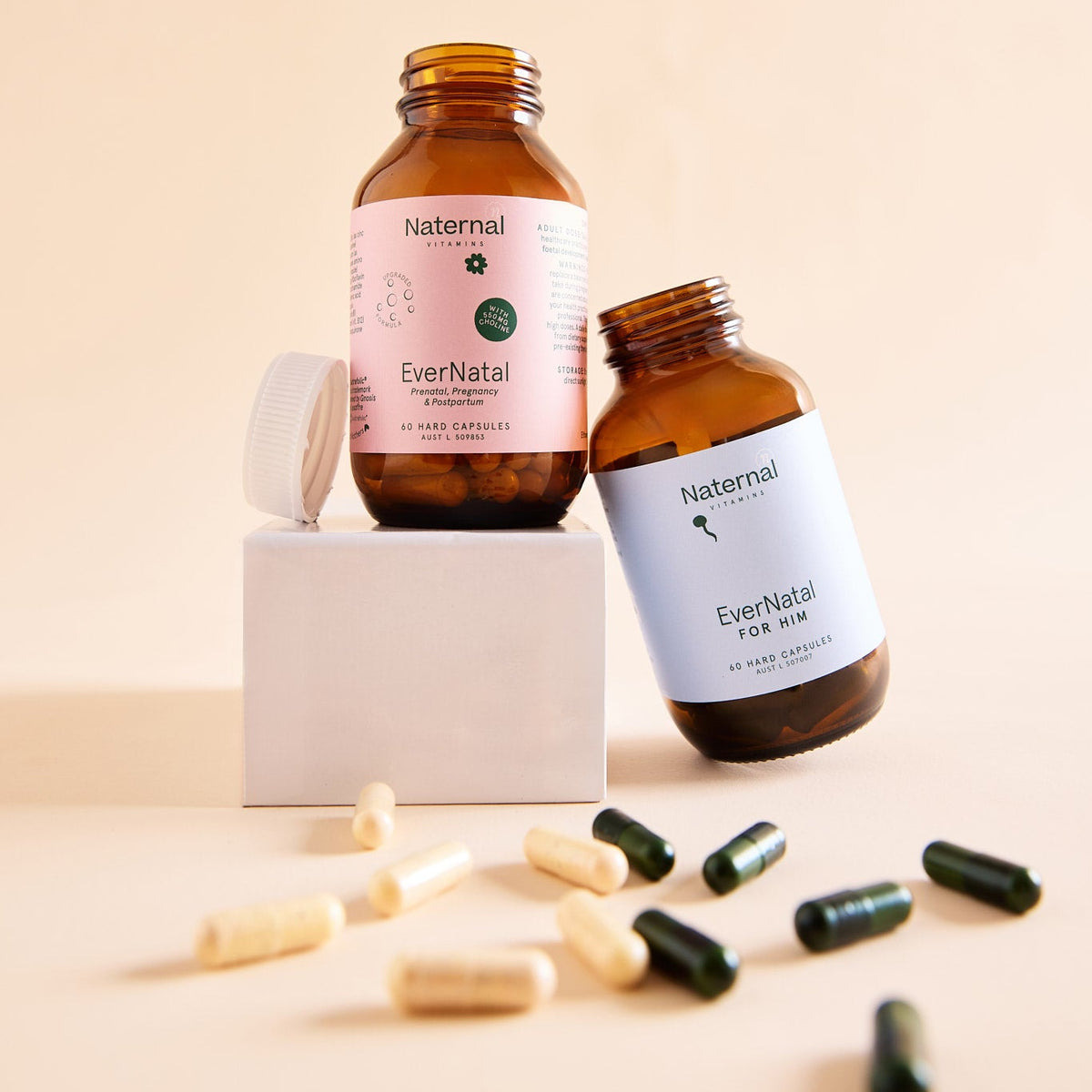 Two bottles of EverNatal on a beige background with scattered capsules.